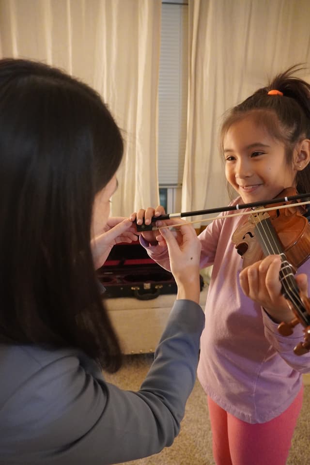 Ting working with a child on posture